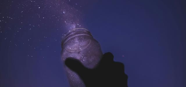 person holding glass jar by Javardh courtesy of Unsplash.