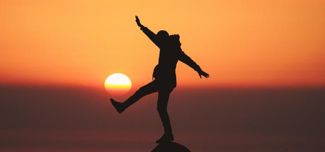 photo of silhouette photo of man standing on rock by Aziz Acharki courtesy of Unsplash.